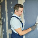 Commercial painter patching a wall to paint
